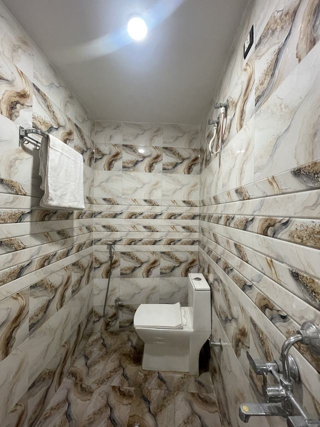 Attached bathroom with western toilet and shower